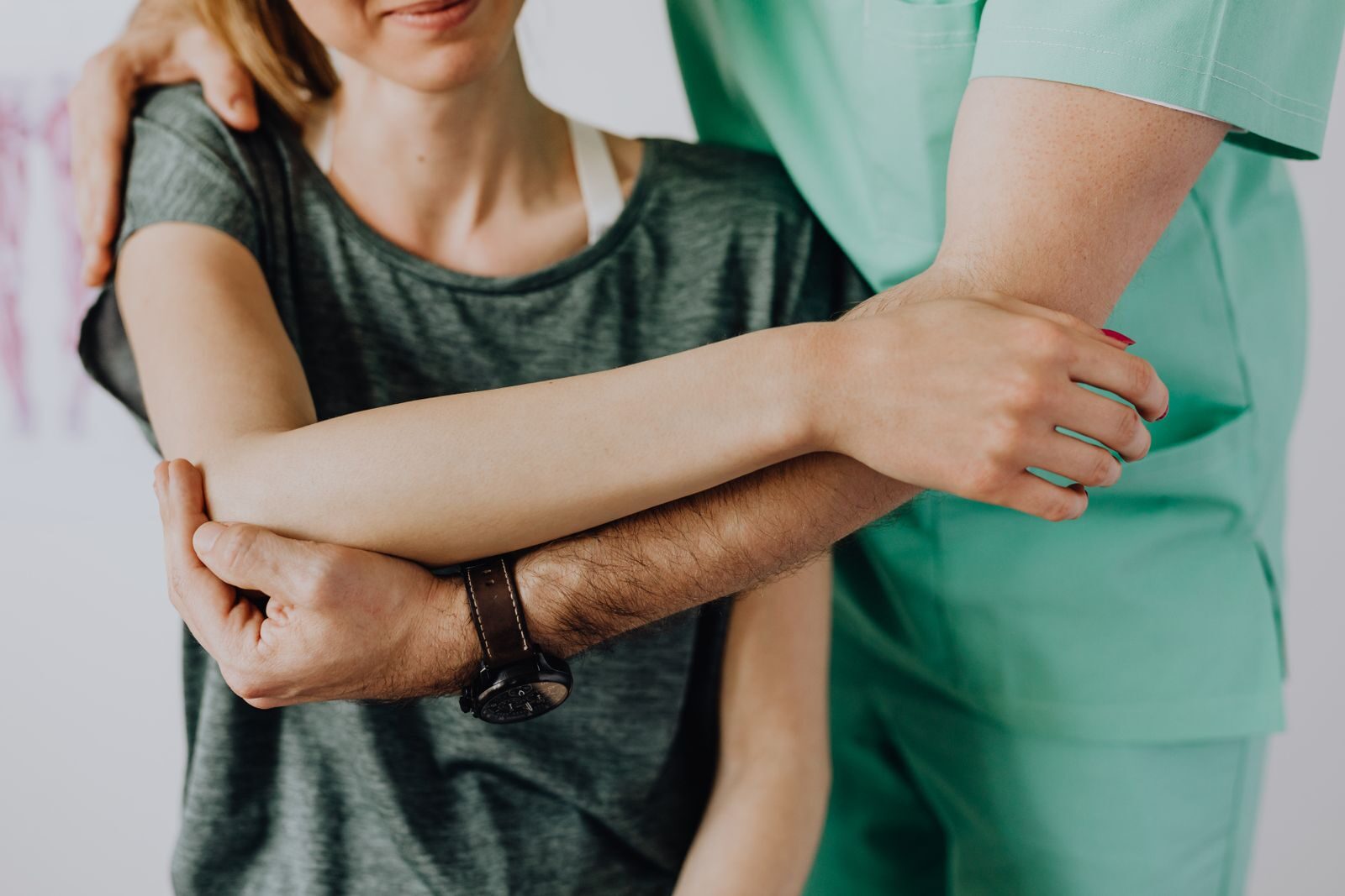 Clinician assessing a patient's shoulder range of motion during a functional evaluation